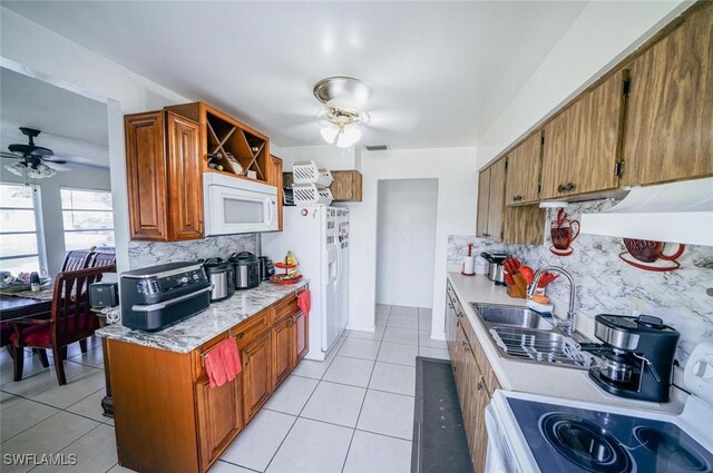 kitchen with white appliances, sink, ceiling fan, light tile patterned floors, and tasteful backsplash