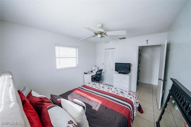 bedroom with ceiling fan, a closet, and light tile patterned flooring