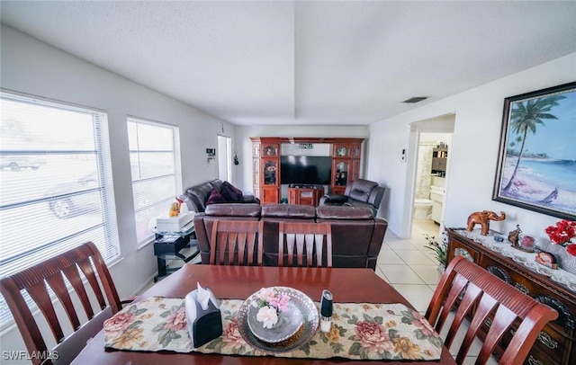 dining space with plenty of natural light and light tile patterned floors