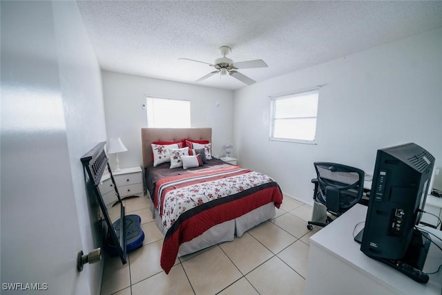 tiled bedroom featuring a textured ceiling and ceiling fan