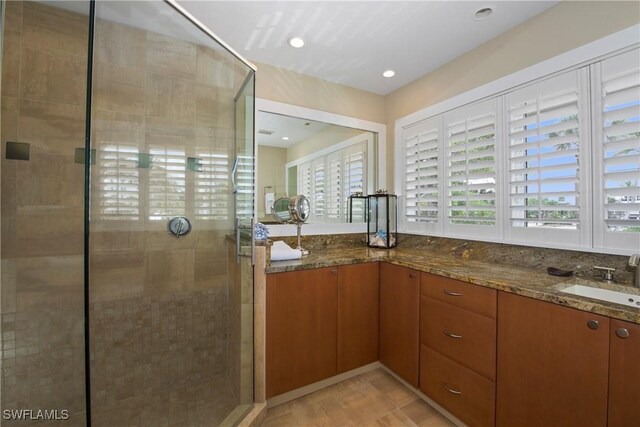 bathroom with sink and an enclosed shower