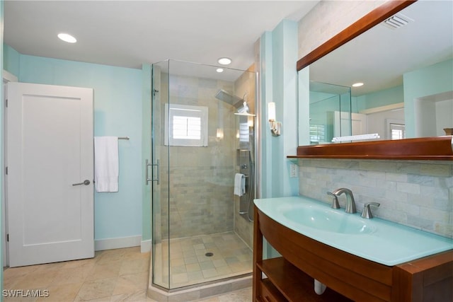 bathroom with decorative backsplash, vanity, and an enclosed shower