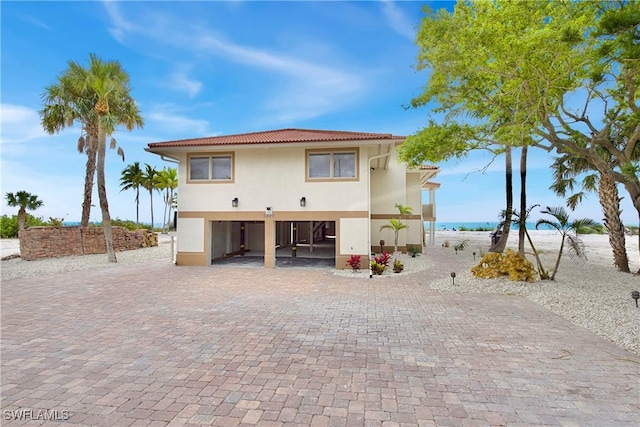 view of front of property with a water view and a carport