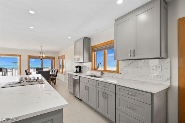 kitchen featuring sink, stainless steel dishwasher, decorative backsplash, gray cabinets, and electric stovetop