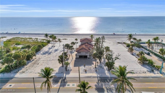 birds eye view of property with a water view and a beach view