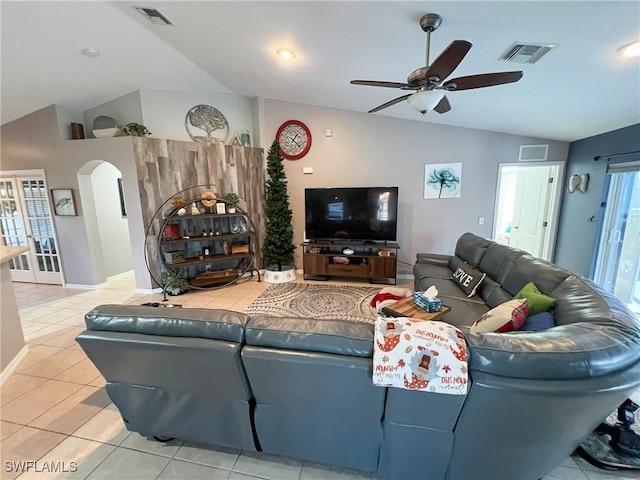 living room featuring light tile patterned floors, vaulted ceiling, ceiling fan, and a healthy amount of sunlight