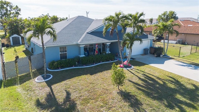 view of front of home featuring a garage, a shed, and a front yard