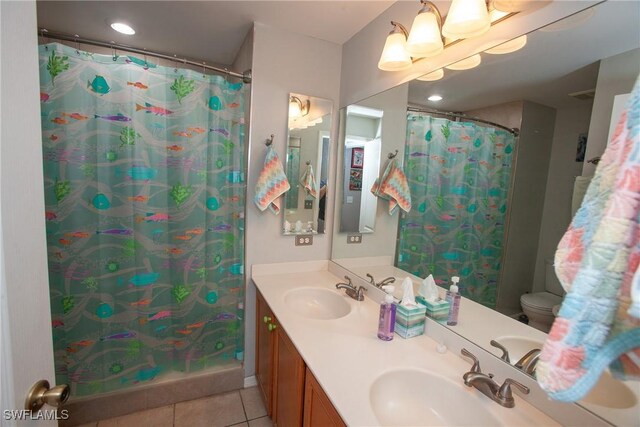 bathroom featuring tile patterned floors, curtained shower, vanity, and toilet