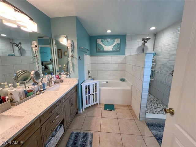 bathroom with tile patterned flooring, vanity, and independent shower and bath