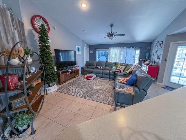 tiled living room with ceiling fan and lofted ceiling