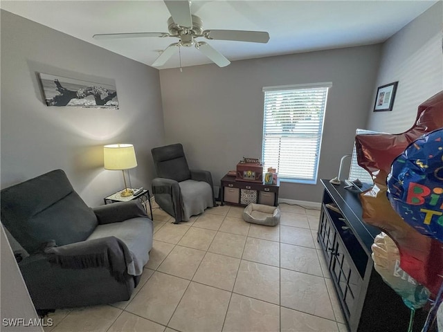 sitting room with ceiling fan and light tile patterned floors