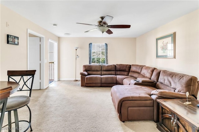 carpeted living room with ceiling fan