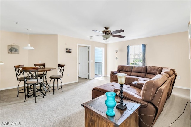 living room with ceiling fan and light colored carpet