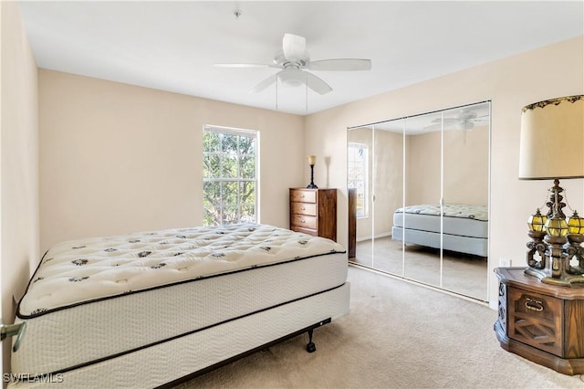 carpeted bedroom featuring a closet and ceiling fan