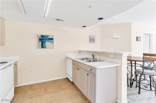 kitchen featuring a kitchen bar, kitchen peninsula, sink, pendant lighting, and dishwasher