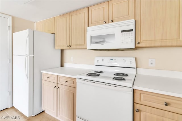 kitchen with light brown cabinets, white appliances, and light tile patterned flooring