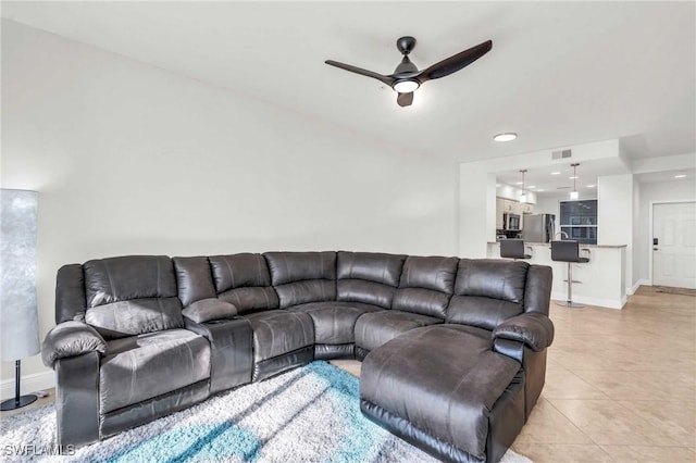 tiled living room featuring ceiling fan