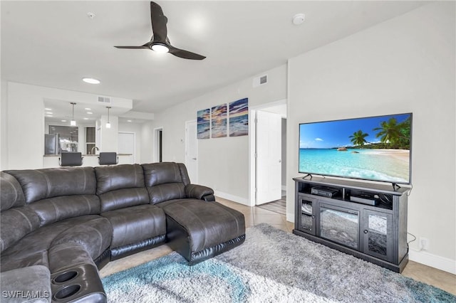 tiled living room with ceiling fan