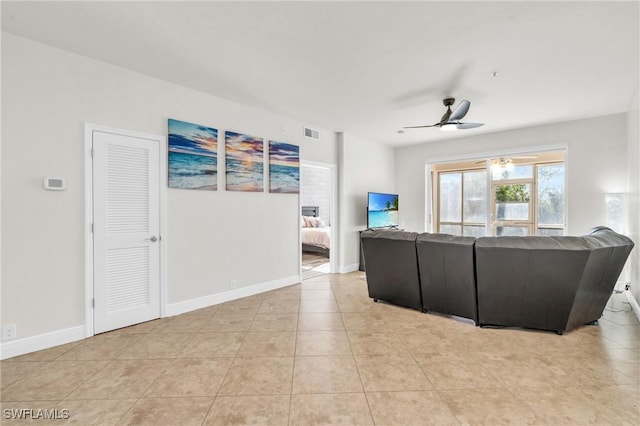 living room featuring light tile patterned floors and ceiling fan