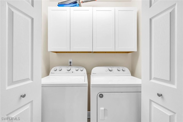 laundry area featuring cabinets and washing machine and dryer