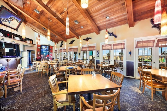 dining room featuring high vaulted ceiling, french doors, wood ceiling, and beamed ceiling