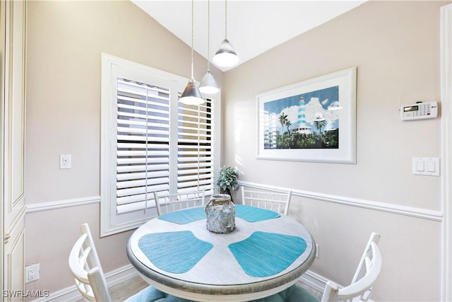 dining space featuring lofted ceiling