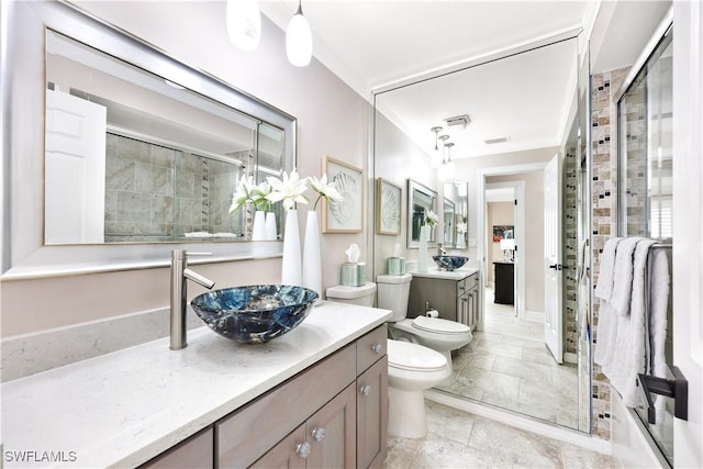 bathroom featuring an enclosed shower, vanity, a bidet, and toilet