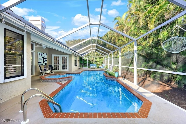 view of pool featuring ceiling fan, a lanai, french doors, and a patio