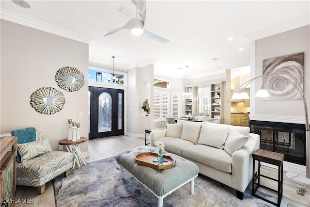 9810 Leeward Ct, Fort Myers, FL 33919 - living room with crown molding, ceiling fan with notable chandelier, light wood-type flooring, baseboards, and recessed lighting