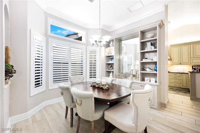 dining room with light hardwood / wood-style flooring, crown molding, and a chandelier