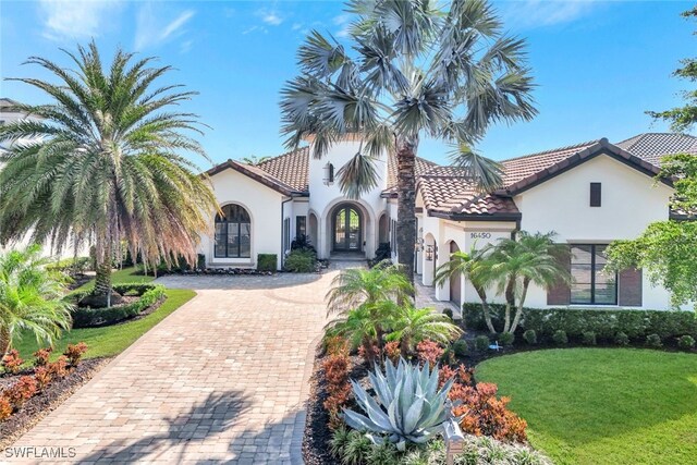 mediterranean / spanish-style house with a front lawn