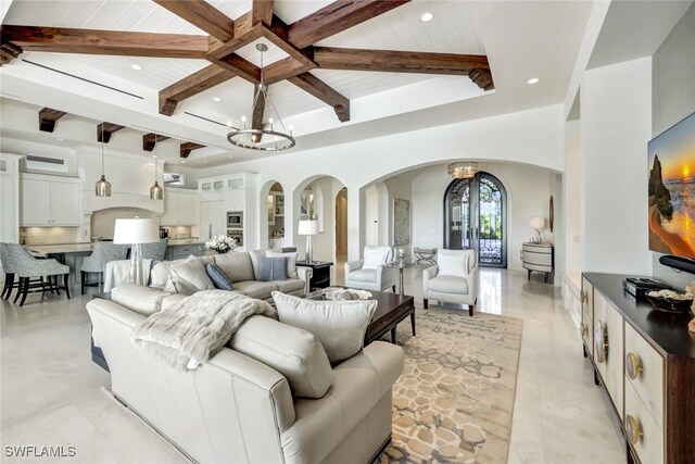 living room with a chandelier, french doors, wooden ceiling, and beamed ceiling