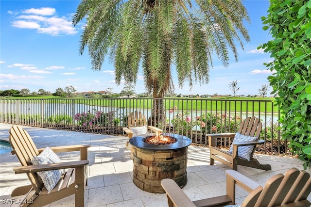 view of patio / terrace with a water view and an outdoor fire pit