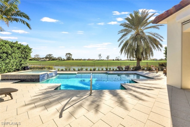 view of swimming pool featuring a patio area, an in ground hot tub, and a water view