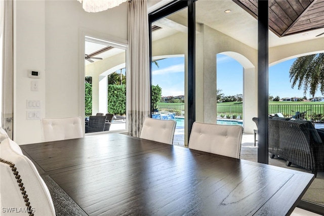 dining room featuring ceiling fan, wood ceiling, and vaulted ceiling