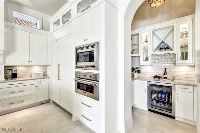 kitchen featuring white cabinets, appliances with stainless steel finishes, and wine cooler