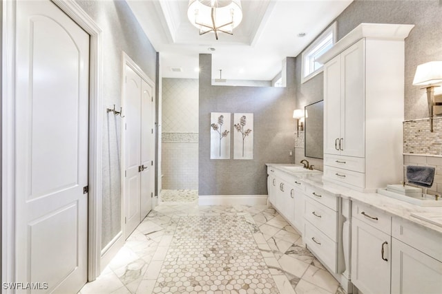 bathroom featuring vanity, a shower, and a tray ceiling