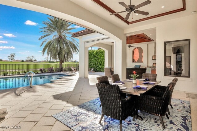 view of patio / terrace with a fenced in pool and ceiling fan