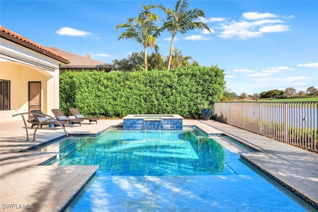 view of swimming pool featuring a patio area and an in ground hot tub