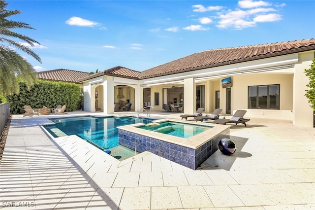 view of pool with an in ground hot tub, ceiling fan, and a patio