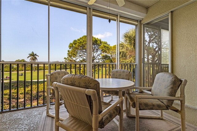 sunroom / solarium featuring ceiling fan