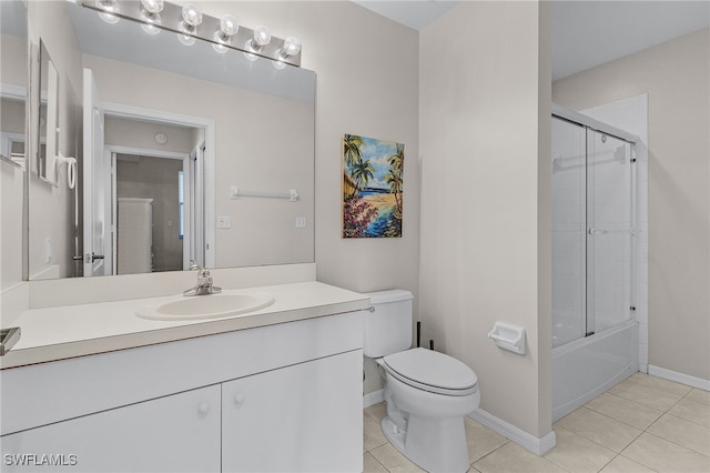 full bathroom with tile patterned floors, vanity, enclosed tub / shower combo, and toilet