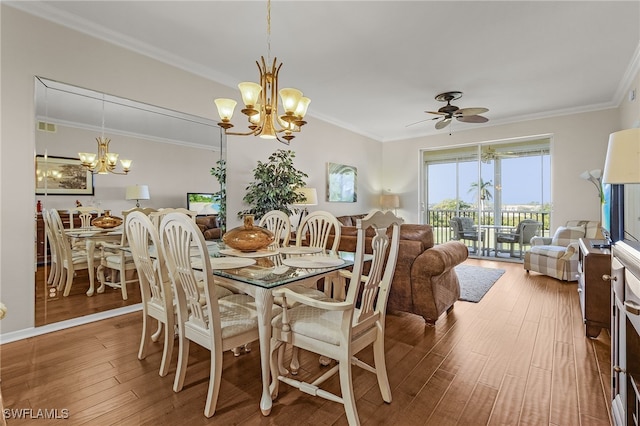 dining room featuring hardwood / wood-style floors, ceiling fan with notable chandelier, and ornamental molding