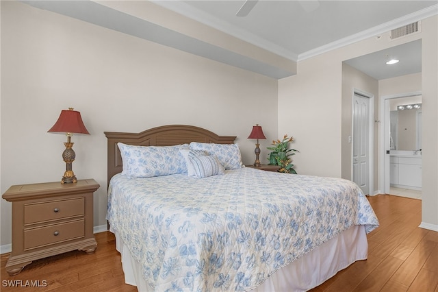 bedroom with connected bathroom, ceiling fan, a closet, and wood-type flooring