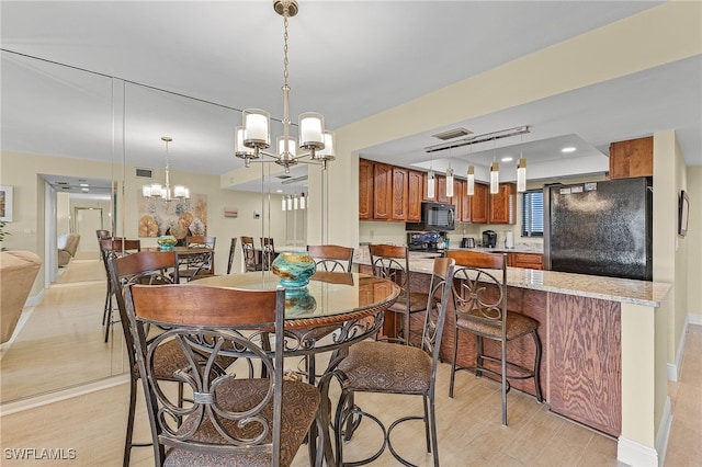 dining space with a notable chandelier