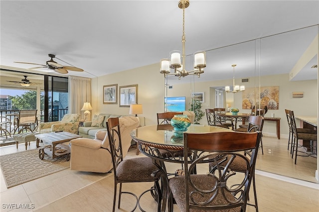 dining space with ceiling fan with notable chandelier