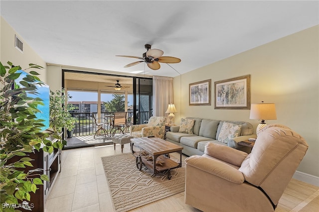 living room featuring ceiling fan and a wall of windows