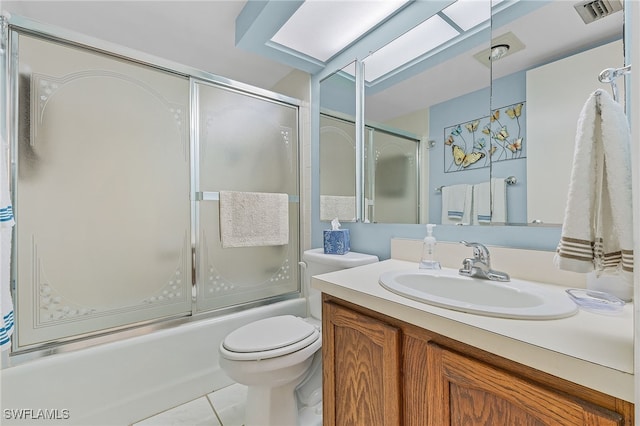 full bathroom featuring tile patterned flooring, combined bath / shower with glass door, toilet, and vanity