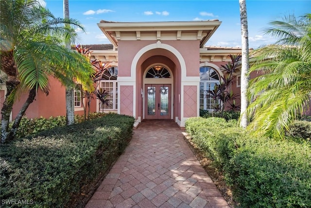 property entrance with french doors and stucco siding