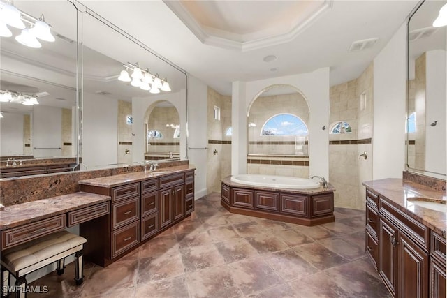 bathroom with vanity, tile walls, a tray ceiling, crown molding, and independent shower and bath